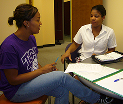 Two women discussing major progress